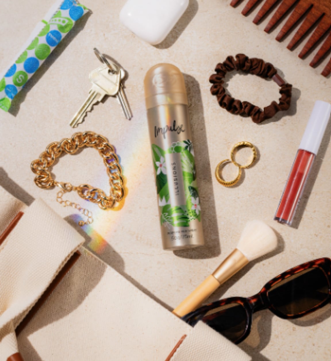 best selling body spray Impulse on a desk with keys, jewellery and make up items